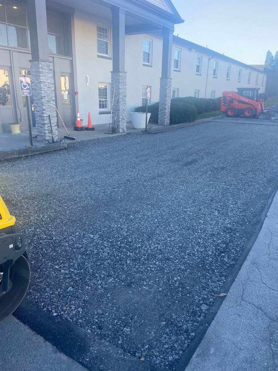 R. Stanley's Paving crew paving a commercial parking lot with a skid steer at a business in the Leesport area.